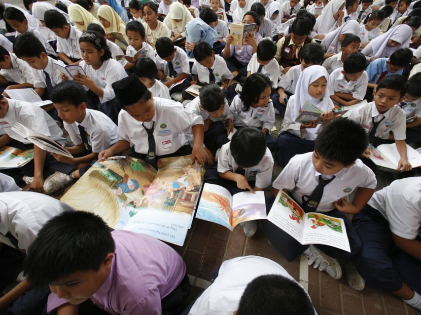 Malaysian children reading books at a school in Putrajaya.