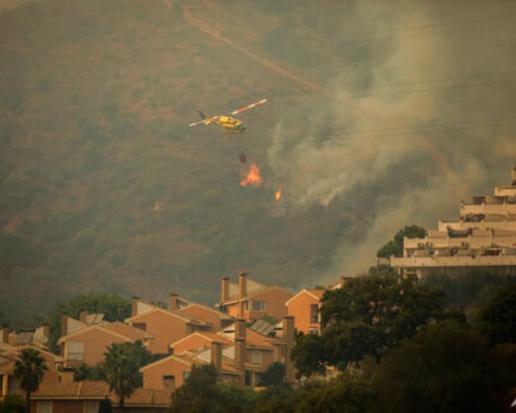 Strong wind complicates fighting wildfire in southeast Spain
