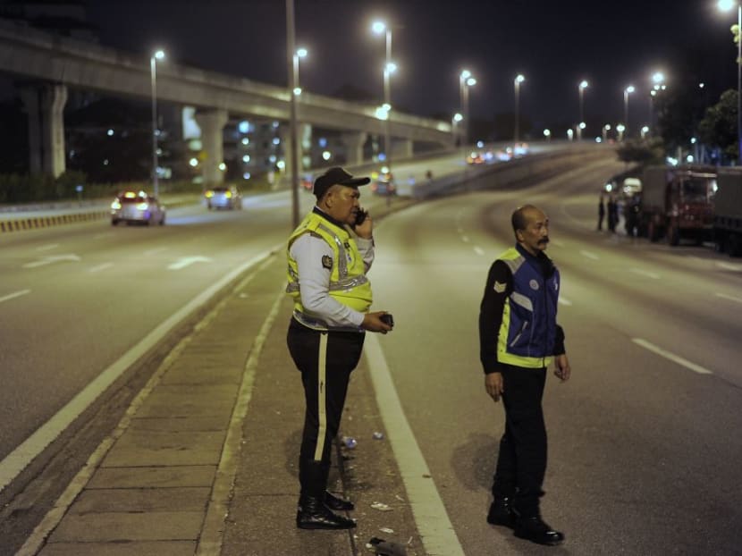 Police personnel stand guard outside the Sri Maha Mariamman Devasthanam temple.