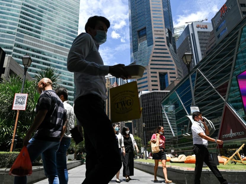 Office workers walking around the Raffles Place financial business district in August 2022. Office workers walking around the Raffles Place financial business district in August 2022.
