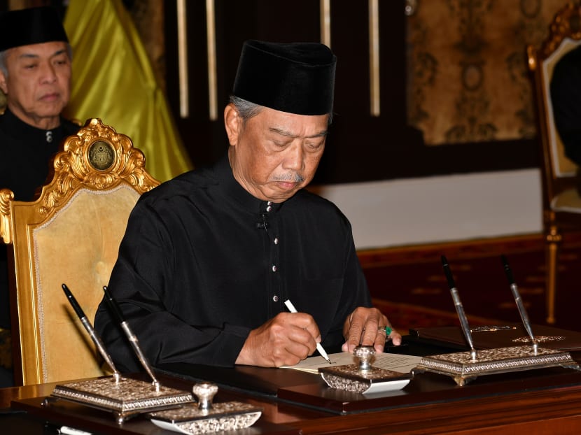 Mr Muhyiddin Yassin signs a document during swearing-in ceremony as Malaysia's prime minister in Kuala Lumpur, Malaysia, March 1, 2020. Mr Muhyiddin Yassin signs a document during swearing-in ceremony as Malaysia's prime minister in Kuala Lumpur, Malaysia, March 1, 2020.