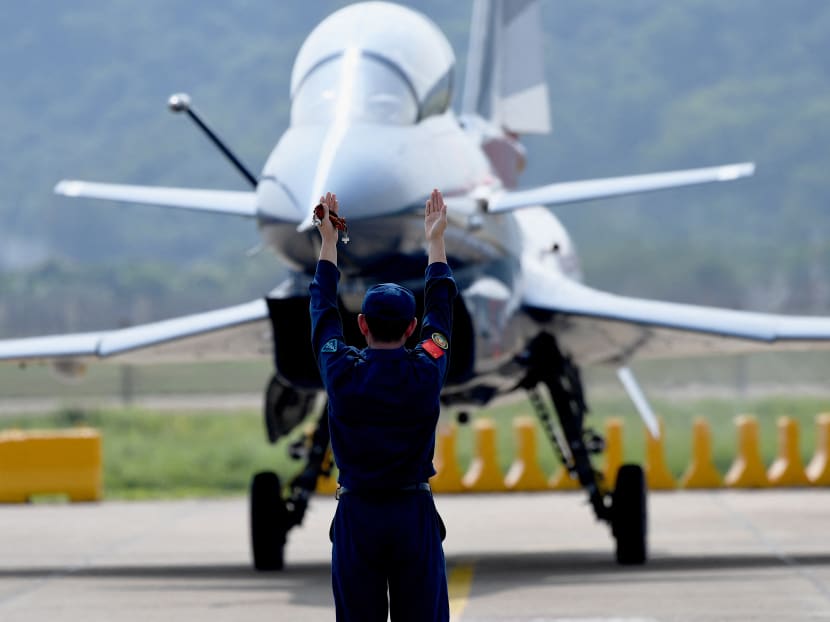 A military personnel guides a Chengdu Aircraft Corporation's J-10 for the People's Liberation Army Air Force after its flight demonstration programme at the 13th China International Aviation and Aerospace Exhibition in Zhuhai, in southern China's Guangdong province on Sept 28, 2021. A military personnel guides a Chengdu Aircraft Corporation's J-10 for the People's Liberation Army Air Force after its flight demonstration programme at the 13th China International Aviation and Aerospace Exhibition in Zhuhai, in southern China's Guangdong province on Sept 28, 2021.