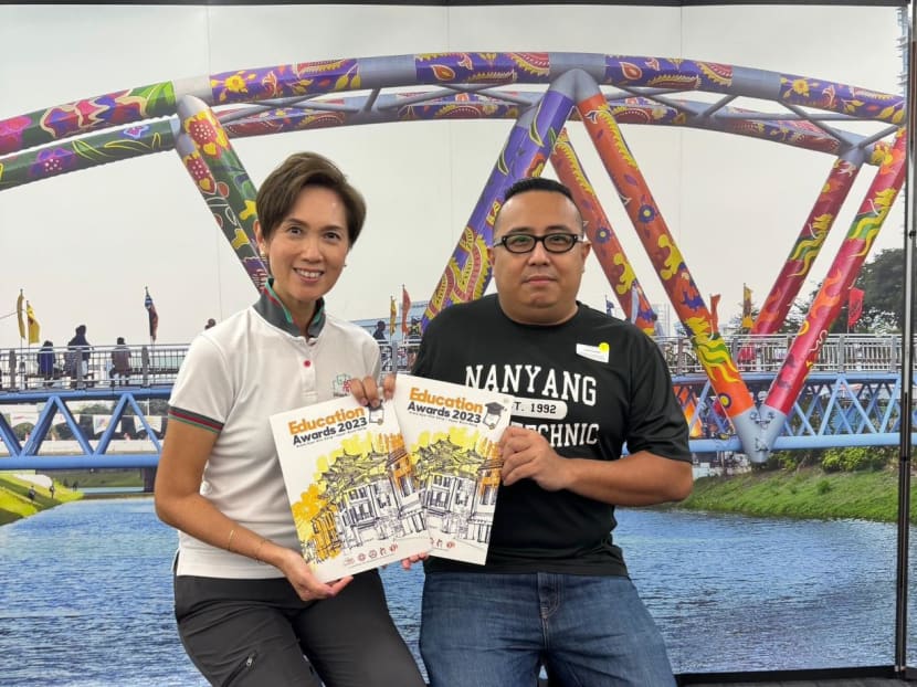 Mr Joshua Huang (right) and Communications and Information Minister Josephine Teo (left) after receiving his Edusave awards.