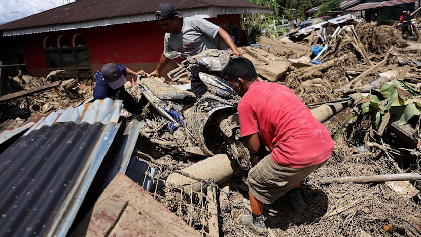 Indonesia flood survivors battle mud, trauma