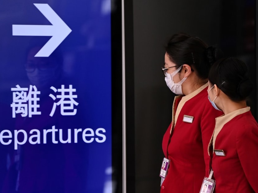 Cathay Pacific employees walk through Hong Kong International Airport on Oct 21, 2020.