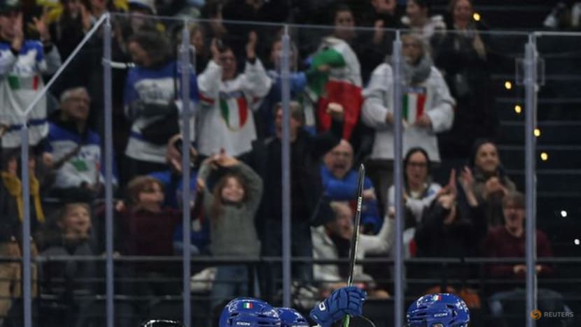 Ice hockey-Italian fans keep party going despite heavy defeat by Sweden