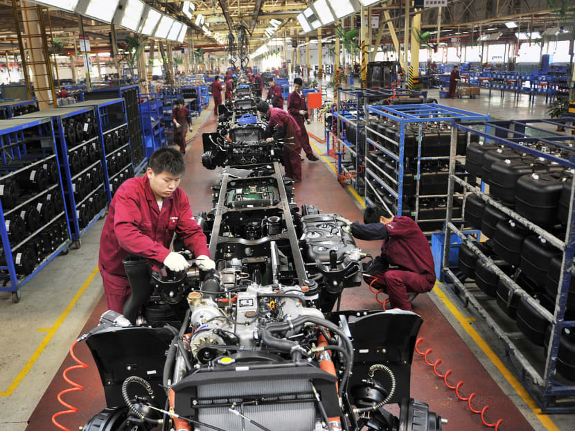 Employees working on a chassis at a truck factory in Hefei, Anhui province, in May. A pullback in manufacturing adds pressure on the Chinese government to step up efforts to meet its expansion target of 7.5 per cent this year. PHOTO: REUTERS