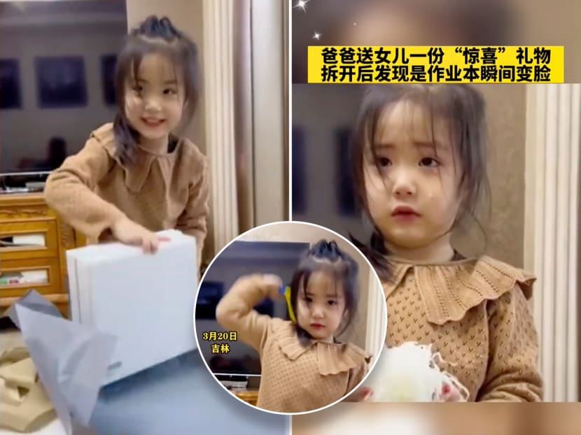 Screenshots from a viral video showing an unnamed girl from China becoming upset after she realised that a "surprise gift" from her father was just an assessment book. 