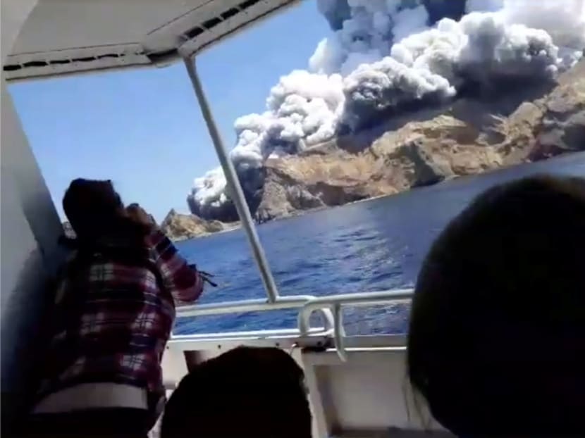 People on a boat react as smoke billows from the volcanic eruption on White Island, New Zealand, on Dec 9, 2019. People on a boat react as smoke billows from the volcanic eruption on White Island, New Zealand, on Dec 9, 2019.
