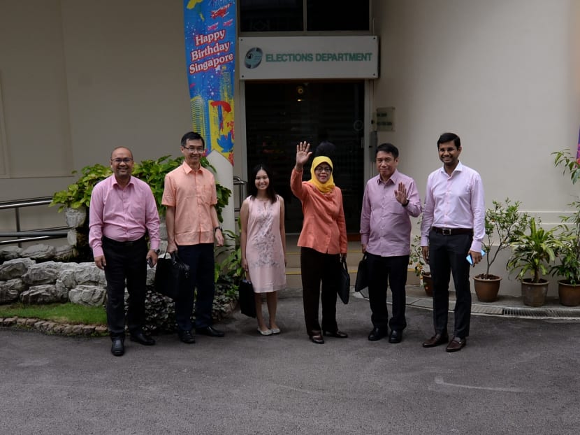 Presidential hopeful Halimah Yacob (third right) and members of her campaign team pose for a photo in front of the Elections Department, on Aug 30.Photo: Robin Choo/TODAY