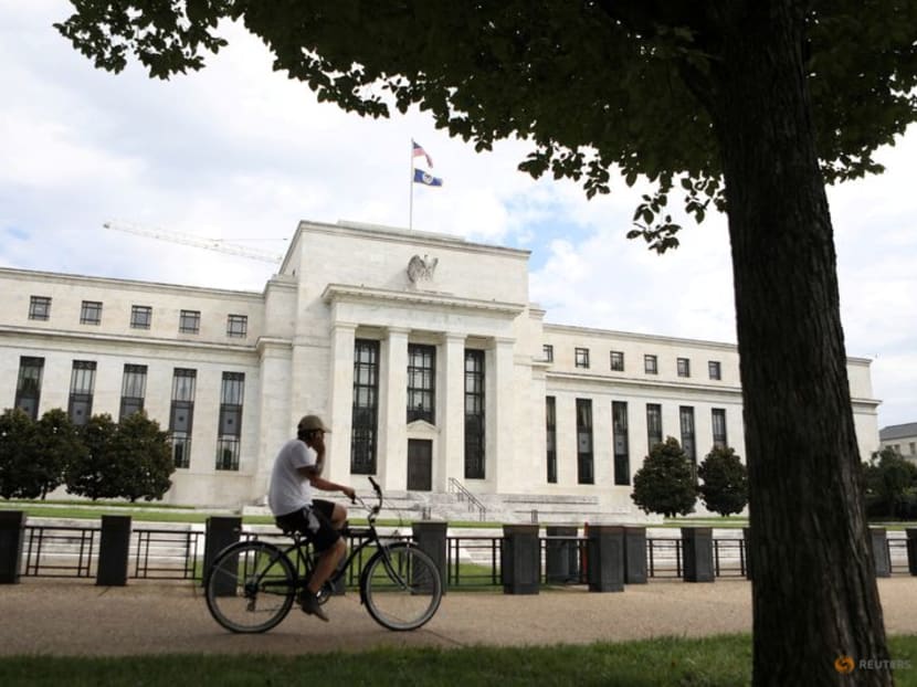 A cyclist passes the Federal Reserve building in Washington, DC, US, on Aug 22, 2018.