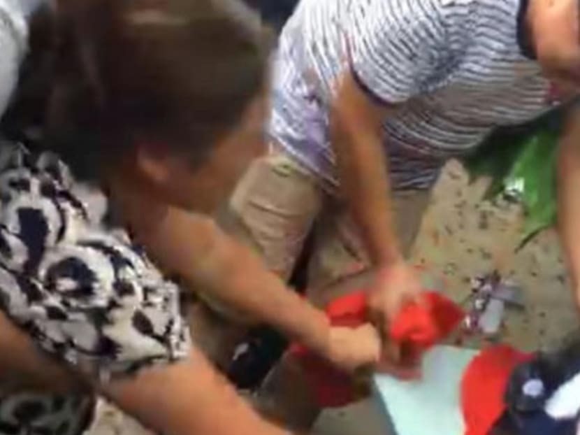 Relatives mourn the death of the woman in Anhui province. Photo via SCMP