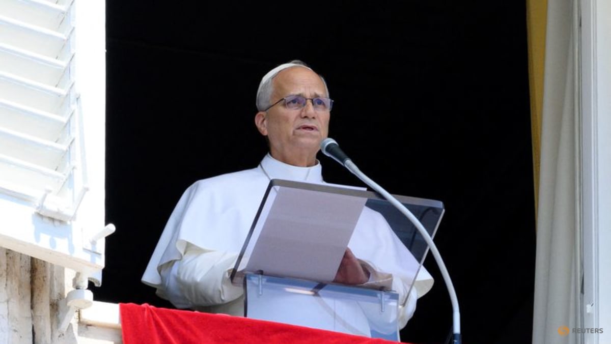 Cleric speaking at a podium outdoors.