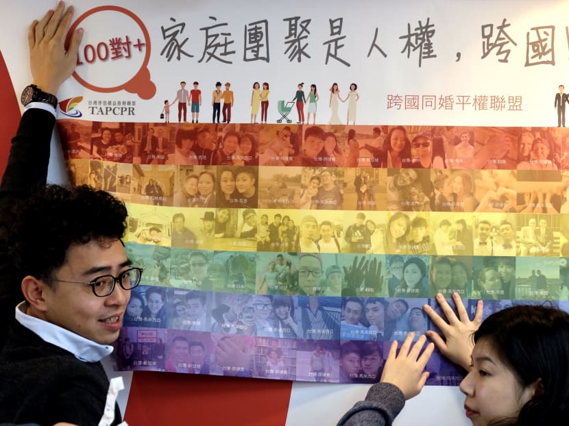Activists from the Taiwan Alliance to Promote Civil Partnership Rights unfurl a poster in support of same-sex marriage during a press conference in Taipei on Jan 21, 2020.