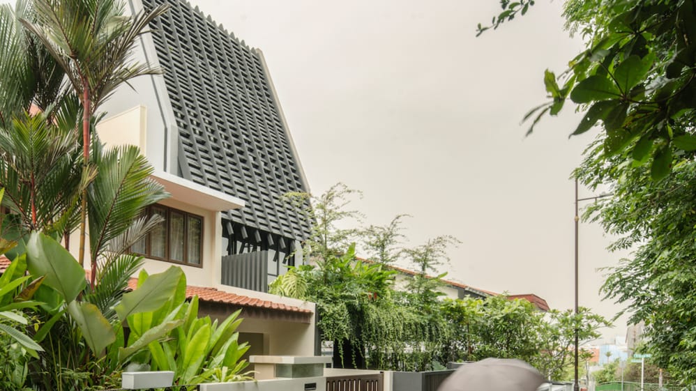 This house in Singapore has an unusual, slanted roof and facade