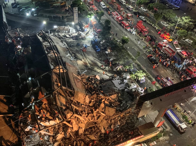 This file photo taken on March 7, 2020 shows rescuers searching for survivors in the rubble of a collapsed hotel in Quanzhou, in China's eastern Fujian province. The death toll from the collapse of a coronavirus quarantine facility in east China rose to 29 on March 12, 2020 as the final victim was recovered from the rubble, authorities said.