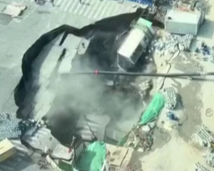Massive sinkhole swallows road, part of construction site near downtown Shanghai