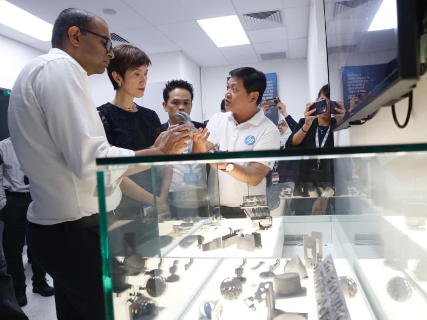 Dr Janil Puthucheary (left), Senior Minister of State for Communications and Information, and Minister for Manpower Josephine Teo (second from left) looking at 3D printed models at HP Singapore’s Smart Manufacturing Applications and Research Centre on Nov 2, 2018.