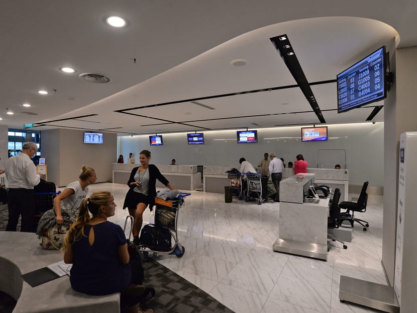Passengers waiting to check-in at the Early Check-In Lounge in Changi Airport Terminal 1. Photo: Robin Choo