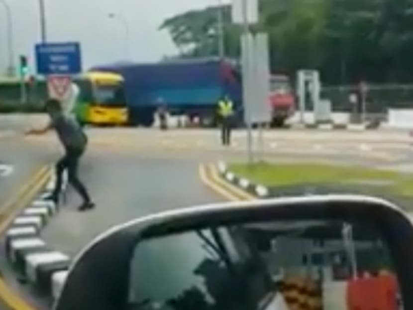 Chew Guan Mong (second from left) was arrested in January 2018, after he had a standoff with law enforcement and security personnel at Woodlands Checkpoint. Images of the incident were posted on social media.