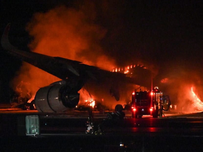 A Japan Airlines (JAL) passenger plane is seen on fire on the tarmac at Tokyo International Airport at Haneda on January 2, 2024. 