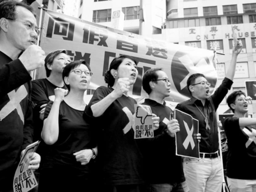 Pro-democracy lawmakers protesting against the government’s electoral reform in Hong Kong on Sunday. From thinking they were important and had a special line of contact with Britain and the West, Hong Kong is finding itself having to accept a very different position in the world. PHOTO: REUTERS