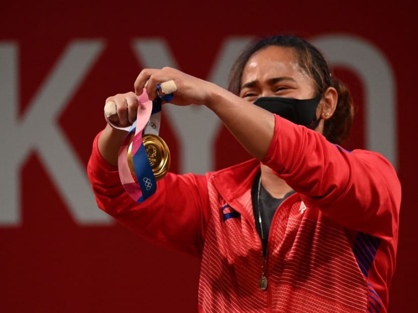 Gold medallist Philippines' Hidilyn Diaz holds her medal on the podium for the victory ceremony of the women's 55kg weightlifting competition during the Tokyo 2020 Olympic Games at the Tokyo International Forum in Tokyo on July 26, 2021.