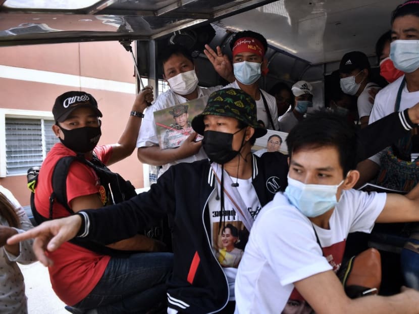 This photo taken on Feb 7, 2021, shows Myanmar migrants in the back of a truck before going to a local protest against the military coup in their home country, in Bangkok.