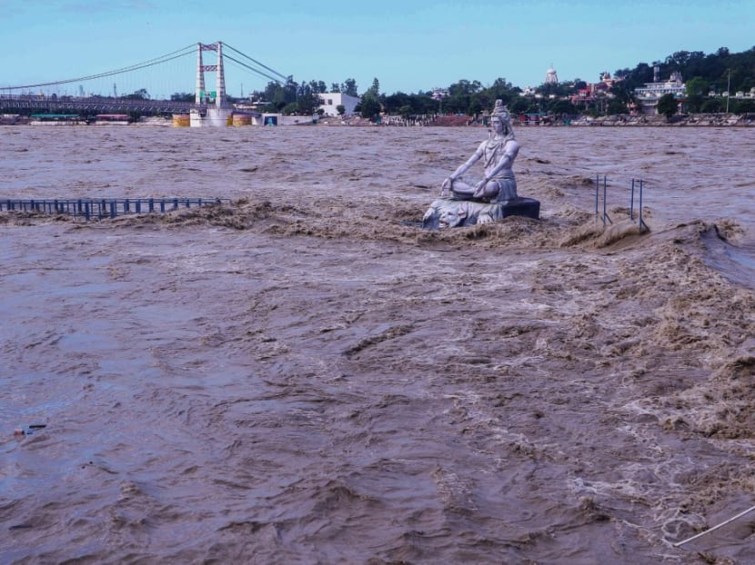 A statue of Hindu god Lord Shiva is pictured amid the risen water levels of River Ganga after incessant rains in Rishikesh in India's Uttrakhand state on Oct 19, 2021.