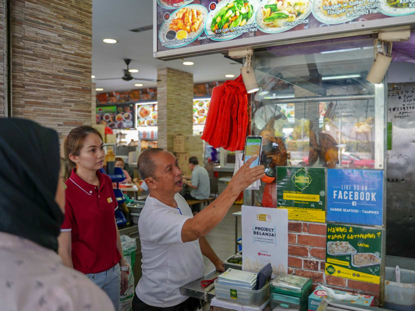 Staff of Habibie Seafood, at the coffee shop of Block 829 Tampines Street 81, demonstrating the seamless claiming process.