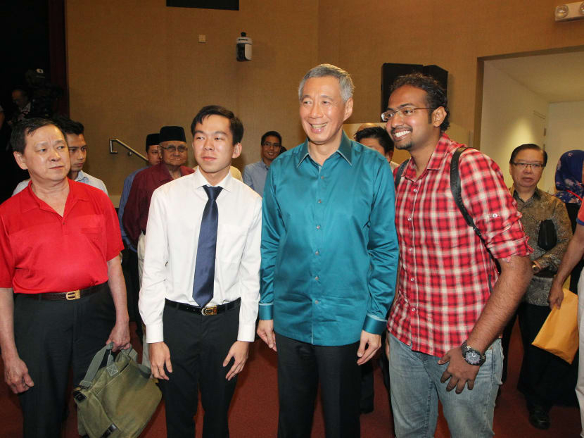 Prime Minister Lee Hsien Loong interacts briefly with Mr William Tay (second from left) and Mr Divesh Singaraju (fourth from left) shortly after delivering his speech at the National Day Rally at the ITE Headquarters and College Central on Aug 17, 2014. Photo: Ooi Boon Keong