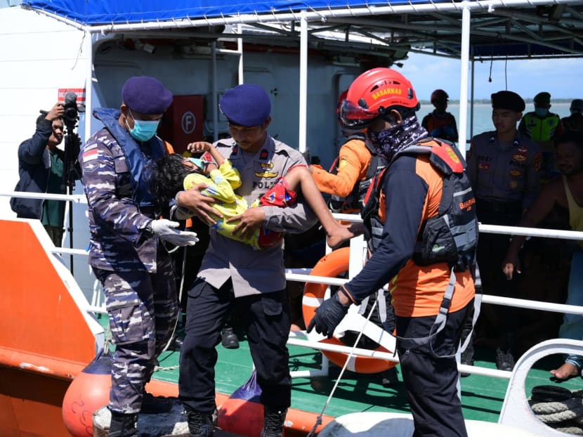 A police officer carries a Rohingya refugee child as they disembark from a National Search and Rescue Agency (BASARNAS) vessel after they were rescued from their capsized boat in waters some 29km off the coast at a port in Meulaboh, West Aceh on March 21, 2024. A police officer carries a Rohingya refugee child as they disembark from a National Search and Rescue Agency (BASARNAS) vessel after they were rescued from their capsized boat in waters some 29km off the coast at a port in Meulaboh, West Aceh on March 21, 2024.