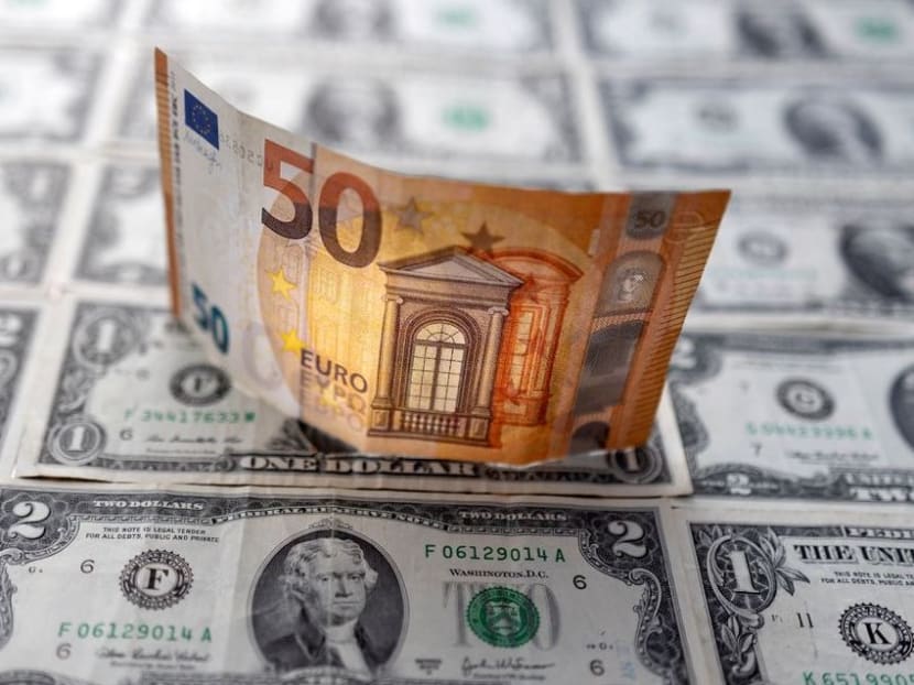 <p>A Euro banknote is displayed on US dollar banknotes in this illustration taken on Feb 14, 2022.&nbsp;</p>
