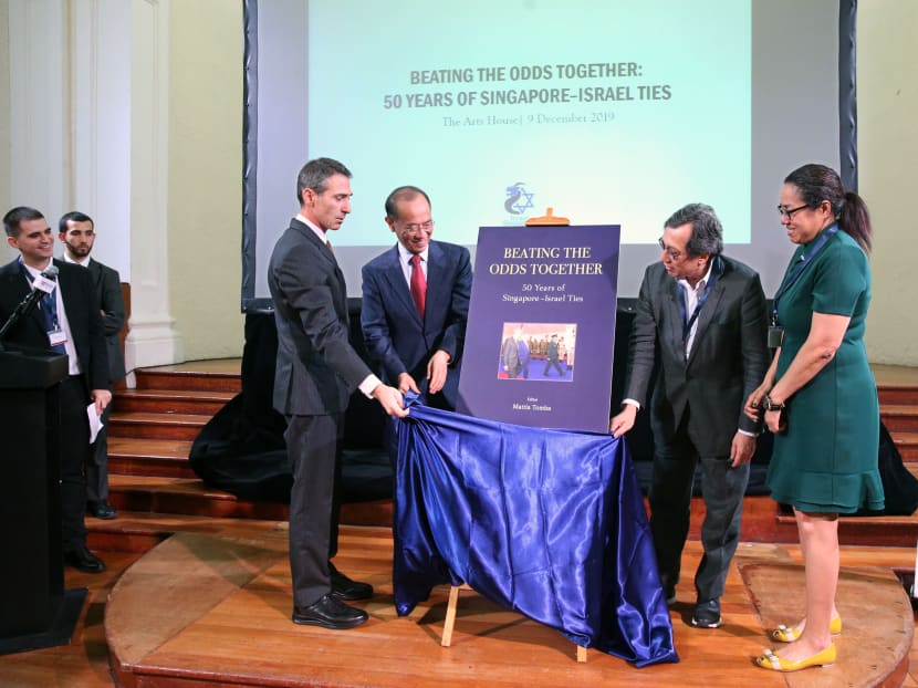 Unveiling the cover of the book, Beating the Odds Together: 50 Years of Singapore-Israel Ties, are (from left) Mr Sagi Karni, ambassador of Israel to Singapore; Mr George Yeo, Singapore's former foreign affairs minister;
Mr Bilahari Kausikan, former permanent secretary of foreign affairs; and Ms Michelle Teo, acting director of the Middle East Institute.