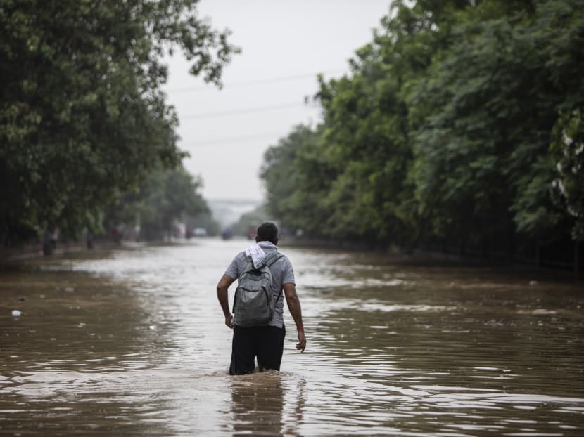 A man walks through a waterlogged street following monsoon rainfalls in Gurgaon on the outskirts of New Delhi on Aug 19, 2020.