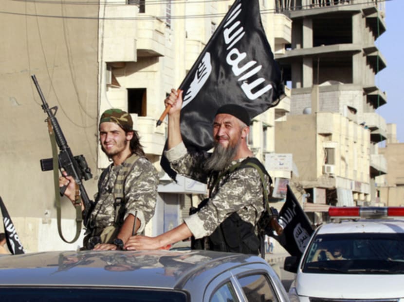 Militant Islamist fighters parading along the streets of Syria late last month. Islamic State reportedly controls at least 
35 per cent of Syria’s territory. PHOTO: REUTERS