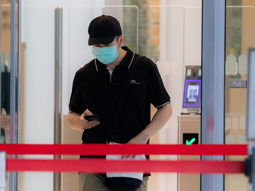 Andy Joshua Warren leaving the State Courts on April 19, 2022. He was fined S$45,000 after pleading guilty to nine counts of cheating.