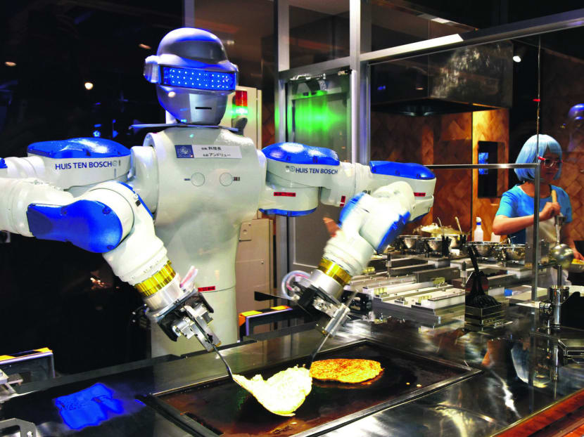 A robot serves Japanese pancakes at a restaurant in the Kingdom of Robots at Huis Ten Bosch, a resort facility in Sasebo in south-western Japan. The automation technology is not advanced enough to operate the restaurant with robots alone, as was initially envisioned. Photo: Kyodo
