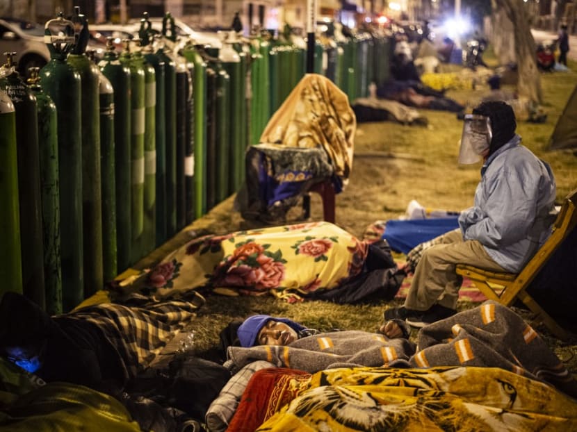 People queue to refill their empty oxygen cylinders in Callao, Peru, on Jan 29, 2021 amid the Covid-19 coronavirus pandemic. Relatives of people with Covid-19 are desperate for oxygen to keep their loves ones alive in Peru, where patients have been dying for lack of oxygen.