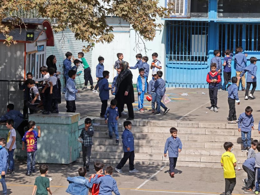 Iranian pupils play together at a school in Tehran on Oct 11, 2022.
