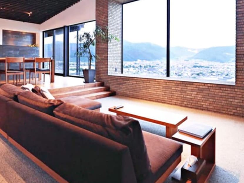 This two-building residence in Japan uses shadows and light to create a rhythm in the living spaces 