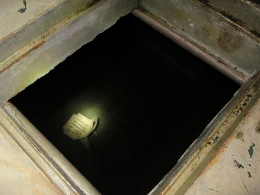 A view showing the manhole where workers entered to clean an underground water tank before it exploded.