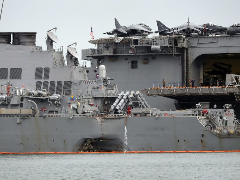 The damaged hull of the USS John S McCain is seen while docked at Singapore's Changi naval base following the collision. Photo: AP
