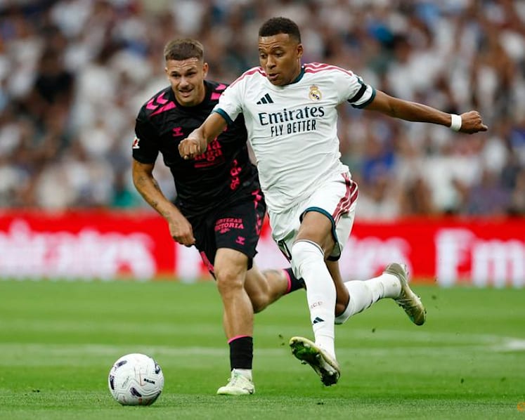 Real Madrid cruise past Malaga 4-0 to maintain perfect start