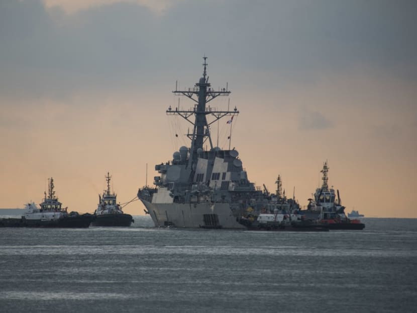 This US Navy photo released on Oct 5, 2017 shows the Arleigh Burke-class guided missile destroyer USS John S. McCain (DDG 56) as it is towed away from the pier at Changi Naval Base, to meet heavy lift transport vessel MV Treasure.