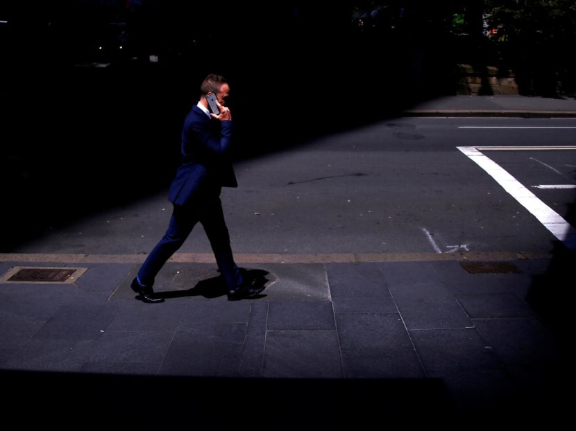 A businessman talks on his mobile phone as he walks along a street in the central business district of Sydney in Australia on Oct 24, 2017.