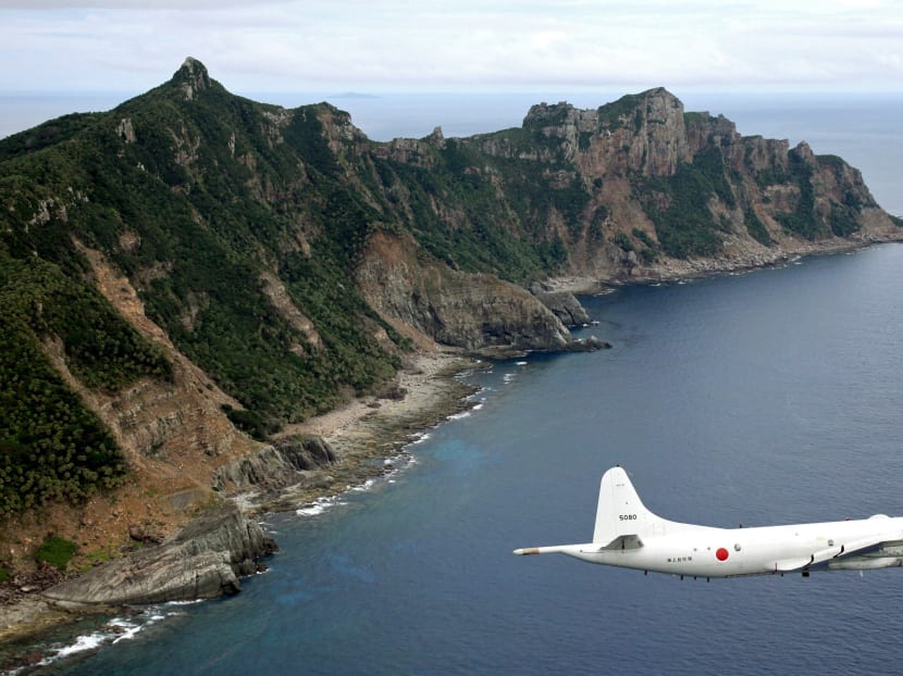 A Japan Maritime Self-Defense Force P-3C Orion surveillance plane flies over the disputed islands, called the Senkaku in Japan and Diaoyu in China, in the East China Sea. Photo: Kyodo News via AP