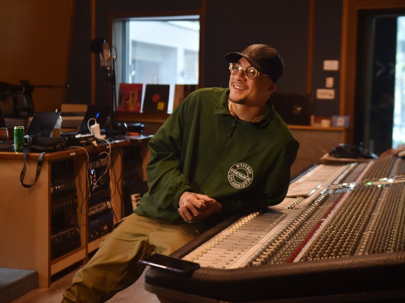 Thai-US rapper Prinya "DaBoyWay" Intachai sits in a studio as he records music in Pattaya.