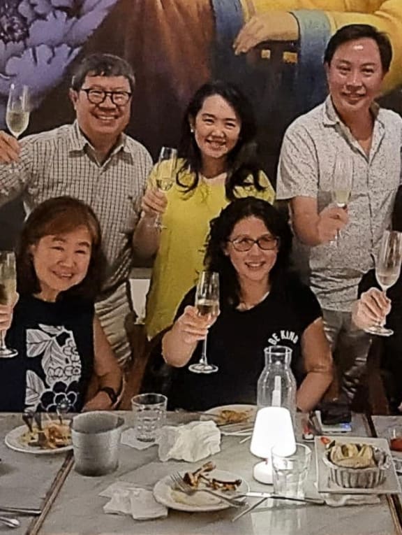 Dr Ronald Yeoh (back row, far left) with his cousins, raising their glasses to actress Michelle Yeoh’s Best Actress Oscar win on March 13, 2023.
 
