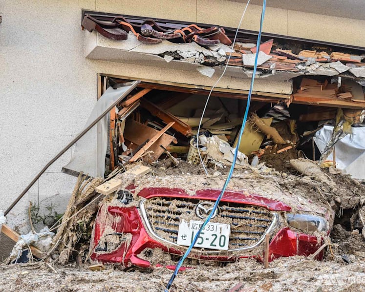 ‘I watched my neighbour get swept away’: Japan flood survivors recall horrors amid search for survivors